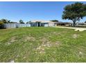 Inviting single-Gathering home with a green lawn, blue siding, white trim, and a welcoming facade on a sunny day at 2018 Misty Morning Dr, Winter Haven, FL 33880