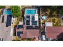 Aerial view of property featuring both a screened pool and a fenced pool at 2213 W Pilaklakaha Ave, Auburndale, FL 33823