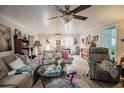 Inviting living room with tongue and groove ceilings, ceiling fan, and comfortable seating at 2213 W Pilaklakaha Ave, Auburndale, FL 33823