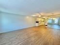 Bright and airy living room featuring hardwood floors, a ceiling fan, and a seamless flow into the kitchen at 254 Winter Ridge Blvd # 254, Winter Haven, FL 33881