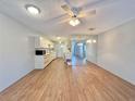 Open floor plan with ceiling fan connecting the living room, dining area, and kitchen space at 254 Winter Ridge Blvd # 254, Winter Haven, FL 33881