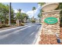 Towncenter Resort entrance with stone gate, lush landscaping, and black iron fence create an inviting atmosphere at 263 Reserve Dr, Davenport, FL 33896