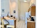 Bright kitchen with white appliances, breakfast bar, and tile flooring at 263 Reserve Dr, Davenport, FL 33896