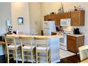 Cozy kitchen with breakfast bar seating and ample cabinet storage space at 263 Reserve Dr, Davenport, FL 33896