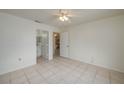 Neutral bedroom with tile flooring; bathroom and kitchen access adds convenience at 299 Winter Ridge Blvd # 299, Winter Haven, FL 33881