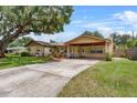 Charming single-story home featuring a covered carport, long driveway and well-manicured landscaping at 320 Boger S Blvd, Lakeland, FL 33803