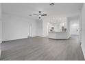 Spacious open-concept living area with sleek, grey flooring, white walls, and natural light flowing in from the exterior at 327 Cloverdale Rd, Winter Haven, FL 33884