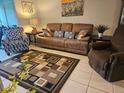 Inviting living room with comfortable seating, stylish rug, and warm decor at 333 Lake Howard Nw Dr # 312D, Winter Haven, FL 33880