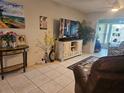 Cozy living space with tile floors, display shelves and entertainment center at 333 Lake Howard Nw Dr # 312D, Winter Haven, FL 33880