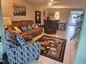 Open living room with tile flooring, modern furnishings, and natural light at 333 Lake Howard Nw Dr # 312D, Winter Haven, FL 33880