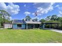 Charming single-Gathering home featuring a covered carport, solar panels, and a well-manicured lawn at 3705 Pine Cir, Lake Wales, FL 33898