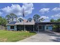 Charming single-Gathering home featuring a covered carport, solar panels, and a well-manicured lawn at 3705 Pine Cir, Lake Wales, FL 33898