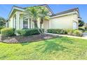 Beautiful home with a well-maintained lawn and mature palm trees at 380 Niblick Cir, Winter Haven, FL 33881