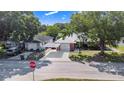This aerial view showcases the home's brick facade, carport, and proximity to neighboring properties at 40 Westridge Rd, Davenport, FL 33837