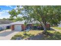 Charming brick home featuring well-maintained front yard and a convenient carport for covered parking at 40 Westridge Rd, Davenport, FL 33837