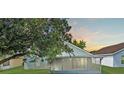 Back exterior featuring screened in porch and a view of the yard and sky at 436 China Berry Cir, Davenport, FL 33837