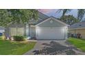 Charming single-story home with a well-maintained lawn, tidy landscaping, and two-car garage at 436 China Berry Cir, Davenport, FL 33837