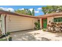 Close up of one-story home with an attached garage and landscaped front yard at 527 Duchess Dr, Lakeland, FL 33803