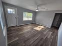 Bright living room featuring luxury vinyl plank floors, updated windows, and fresh neutral paint at 631 Julia Se St, Winter Haven, FL 33880