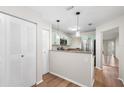 Galley kitchen featuring granite countertops, stainless steel appliances, and wood floors at 703 Magnolia Pl # 703, Winter Haven, FL 33884