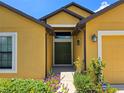 Attractive home featuring a double-door entrance and well-maintained garden at 830 Cabaret Ct, Kissimmee, FL 34759