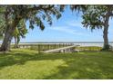 Expansive backyard with well-maintained lawn, dock, and access to waterfront at 8314 W Lake Marion Rd, Haines City, FL 33844
