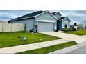 Well-maintained house showcases a manicured lawn, a spacious driveway, and a tidy landscape design at 832 Vienna Dr, Winter Haven, FL 33884