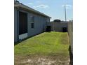 A fenced in side yard with small grass area at 832 Vienna Dr, Winter Haven, FL 33884