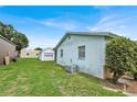 Backyard showing the house, storage shed, and pool with screened enclosure at 109 Dakota Ave, St Cloud, FL 34769