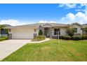 Charming single-story home with a two-car garage, stone accents, and a well-maintained lawn at 114 Belmont Dr, Winter Haven, FL 33884