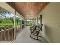 View of the long and screened in porch with chairs and a ceiling fan providing a relaxing outdoor space at 1256 Center St, Lake Wales, FL 33859