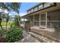 The exterior of the home features a screened-in porch perfect for enjoying the outdoors while being protected from insects at 1256 Center St, Lake Wales, FL 33859