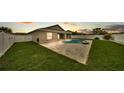 A private backyard featuring an in-ground pool, patio, and well-maintained lawn at 1765 Kingsmill Dr, Bartow, FL 33830
