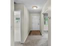 Inviting entryway with neutral paint, carpet flooring, and an interior door at 1810 Roanoke Ave, Lakeland, FL 33803