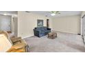 Spacious living room with plush carpet and a ceiling fan at 1810 Roanoke Ave, Lakeland, FL 33803