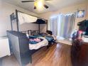 A bedroom with a bunk bed, wood floors, and a window at 1836 N Crystal Lake Dr, Lakeland, FL 33801