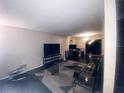View of a living room featuring a geometric patterned rug, modern furniture and a TV at 1836 N Crystal Lake Dr, Lakeland, FL 33801