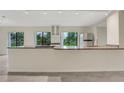 Bright kitchen with granite countertops, stainless steel appliances, and modern cabinets at 208 Lake Howard Nw Dr # 104, Winter Haven, FL 33880