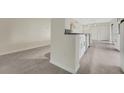 Modern kitchen features sleek white cabinetry and stainless steel appliances, with stylish tile flooring at 208 Lake Howard Nw Dr # 104, Winter Haven, FL 33880