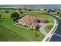 An aerial view of this home showcases the surrounding landscape and screened-in lanai at 209 Pine Lilly Ct, Lake Alfred, FL 33850