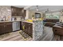 Inviting kitchen with granite counters, stainless steel appliances, and open view to the living room at 2480 Avenue E Sw, Winter Haven, FL 33880