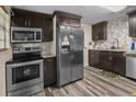 Well-equipped kitchen featuring stainless steel appliances, stone counters, and dark cabinetry at 2480 Avenue E Sw, Winter Haven, FL 33880