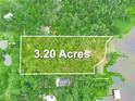 Picturesque aerial view of a 3.2-acre lot surrounded by lush greenery and natural landscape near a body of water at 2530 Arbuckle Shores Rd, Frostproof, FL 33843