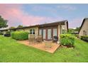 Enjoyable backyard including luscious greenery and outdoor seating for relaxation and entertainment on a comfortable concrete patio at 2835 Wingfoot Ct, Winter Haven, FL 33884