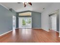 Bright living room with wood floors, large glass sliding door and transom window for lots of natural light at 362 Lake Daisy Cir, Winter Haven, FL 33884