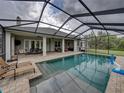 Screened-in pool with ample seating, perfect for outdoor relaxation and entertainment at 3985 Mammoth Grove Rd, Lake Wales, FL 33898