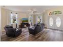 Comfortable living room featuring hardwood floors, a ceiling fan, and a entertainment center at 4338 Dinner Lake Blvd, Lake Wales, FL 33859