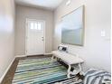 Welcoming front entrance featuring stylish decor, an accent bench, and a modern front door with glass pane window at 481 Kensington View Dr, Winter Haven, FL 33880