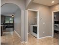 Hallway featuring tile floors leading to the living room, laundry room and bedroom at 536 Squires Grove Dr, Winter Haven, FL 33880