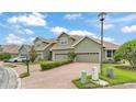 Row of townhouses with brick driveways, green lawns, and attractive landscaping at 6528 Sedgeford Dr, Lakeland, FL 33811